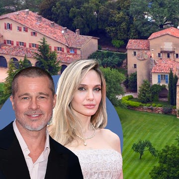 Aerial view of a large, elegant villa surrounded by lush greenery.