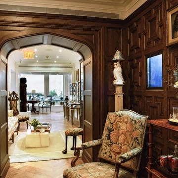 Interior view showcasing a stylish room with ornate wooden paneling and furniture.