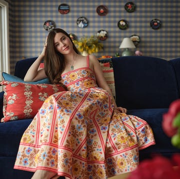 a person sitting on a blue couch in a cozy room