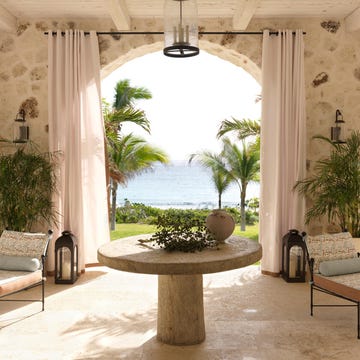 Photograph of a loggia by the sea with a table and two benches. Photograph of a loggia by the sea with a table and two benches.