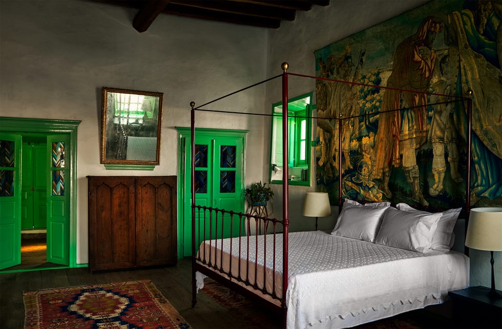 A cozy bedroom with unique green details and vintage decor.