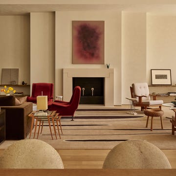 Modern living room with various seating arrangements and decor elements.