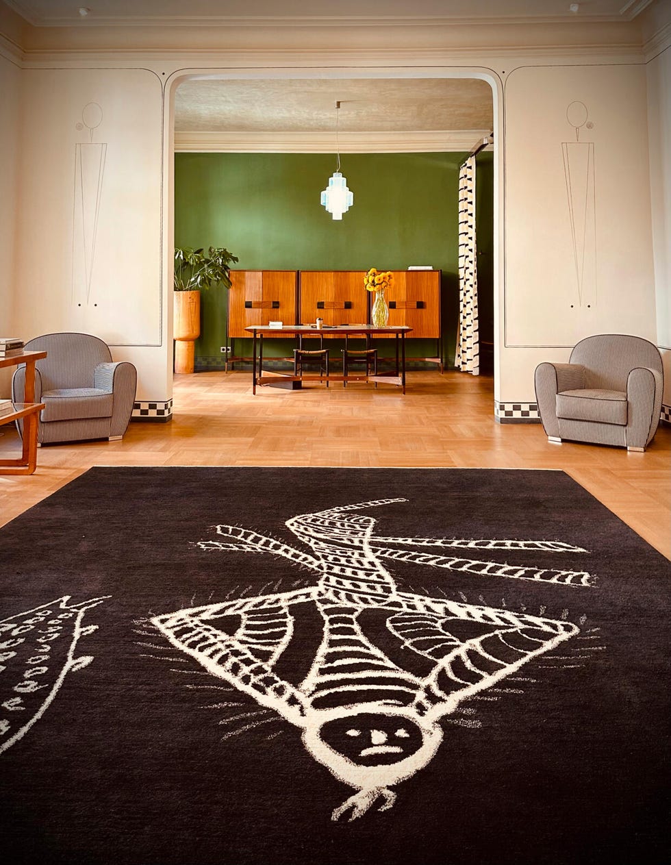 Interior space featuring a prominent rug design and modern furniture.