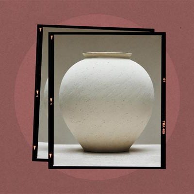 Ceramic vase with a round body and a small neck.