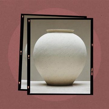 Ceramic vase with a round body and a small neck.