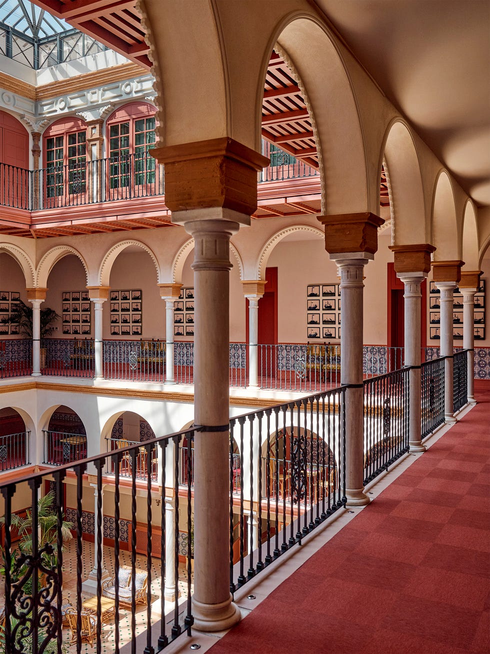 Interior view of a historical courtyard with arches and balconies