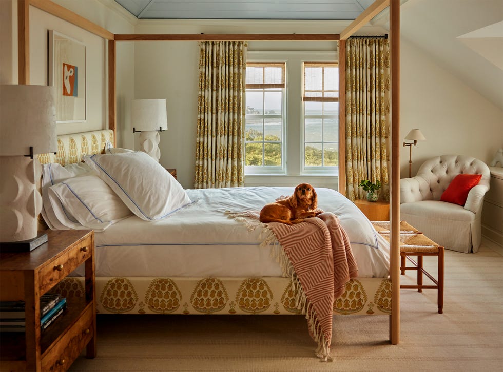 Cozy bedroom featuring a bed with a dog resting on it.
