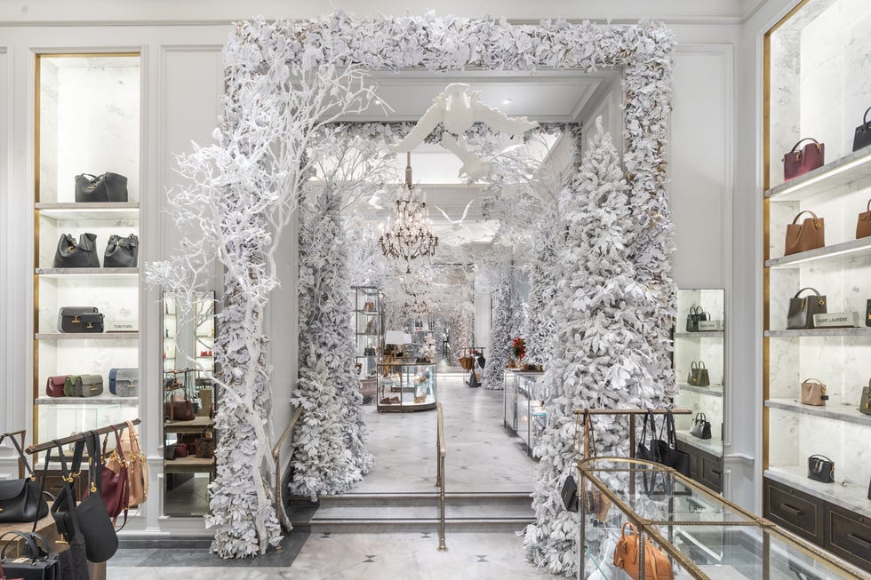 an entryway framed by snow covered trees and garlands, with a goose flying through.