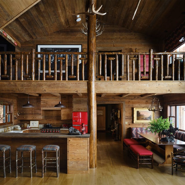 Rustic kitchen and dining area in a wooden cabin.