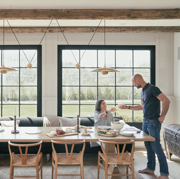 a modern dining area featuring a long table set for a meal