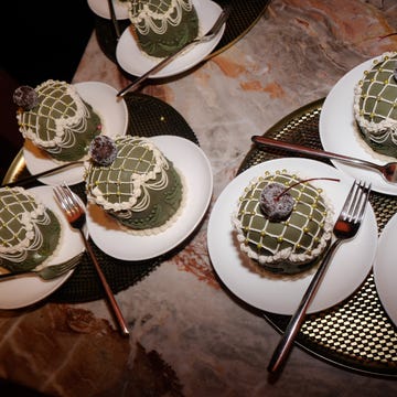 Desserts arranged on plates with forks on a table