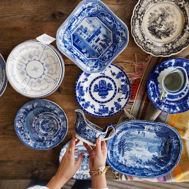Collection of blue and white ceramics arranged on a wooden table.