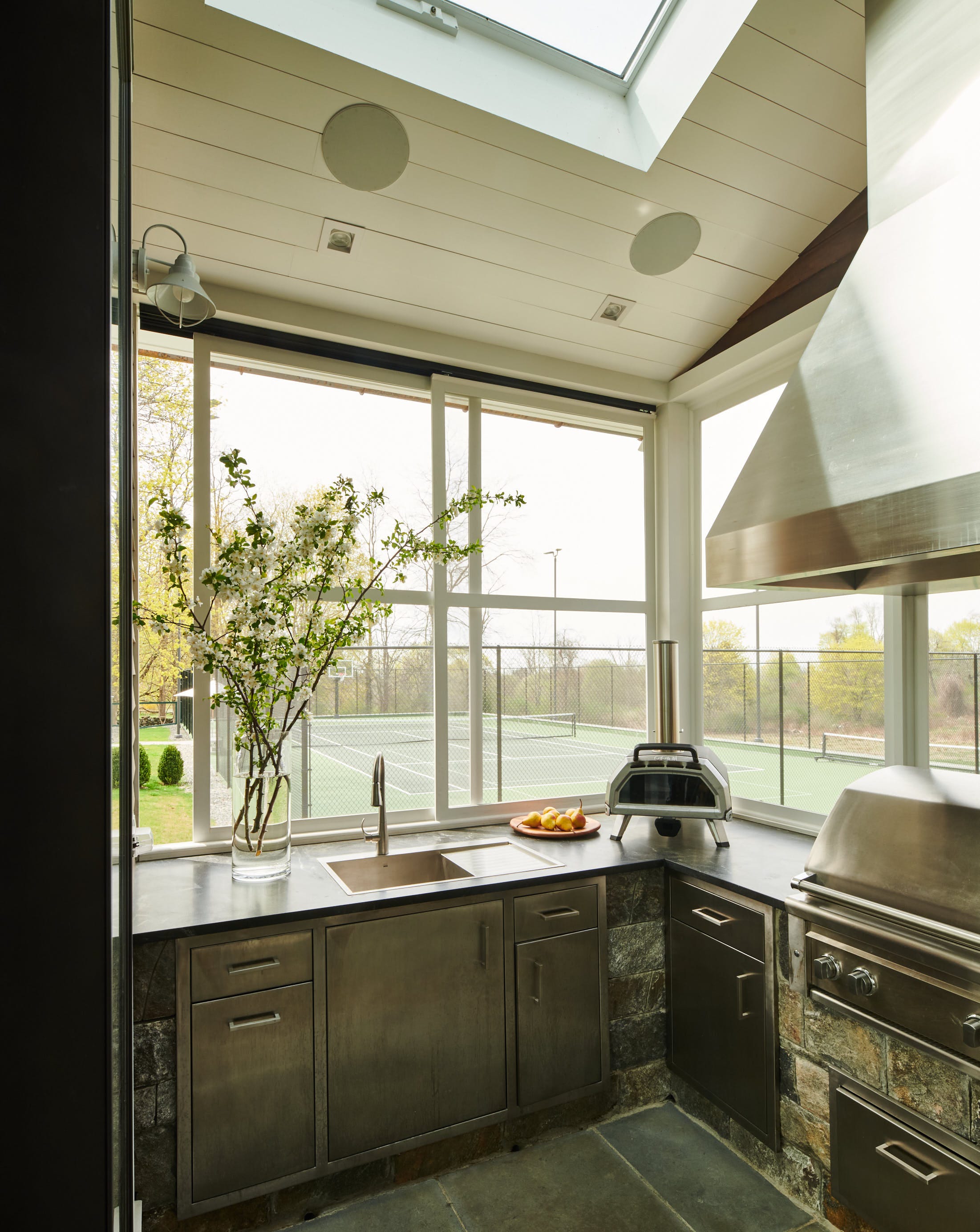 modern kitchen with a view of a tennis court