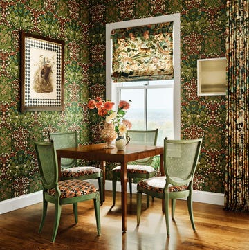 dining area featuring a table chairs floral arrangement and decorative wall elements