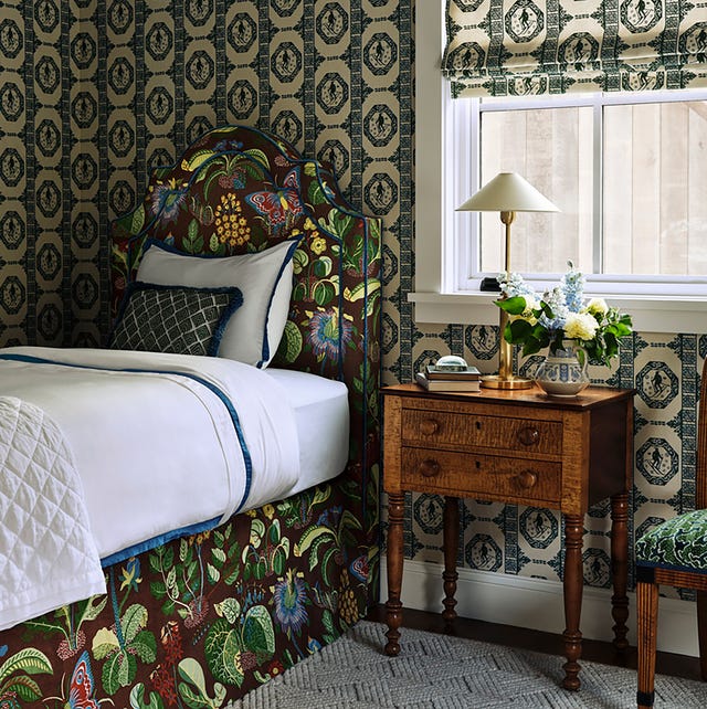 Cozy bedroom featuring a floral headboard and vintage furniture Cozy bedroom featuring a floral headboard and vintage furniture