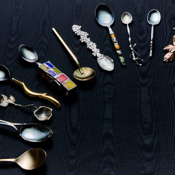 a selection of artisanal spoons ranging from gold to silver to mosaic handles and pieces with ribbon details on a black moire background a selection of artisanal spoons ranging from gold to silver to mosaic handles and pieces with ribbon details on a black moire background