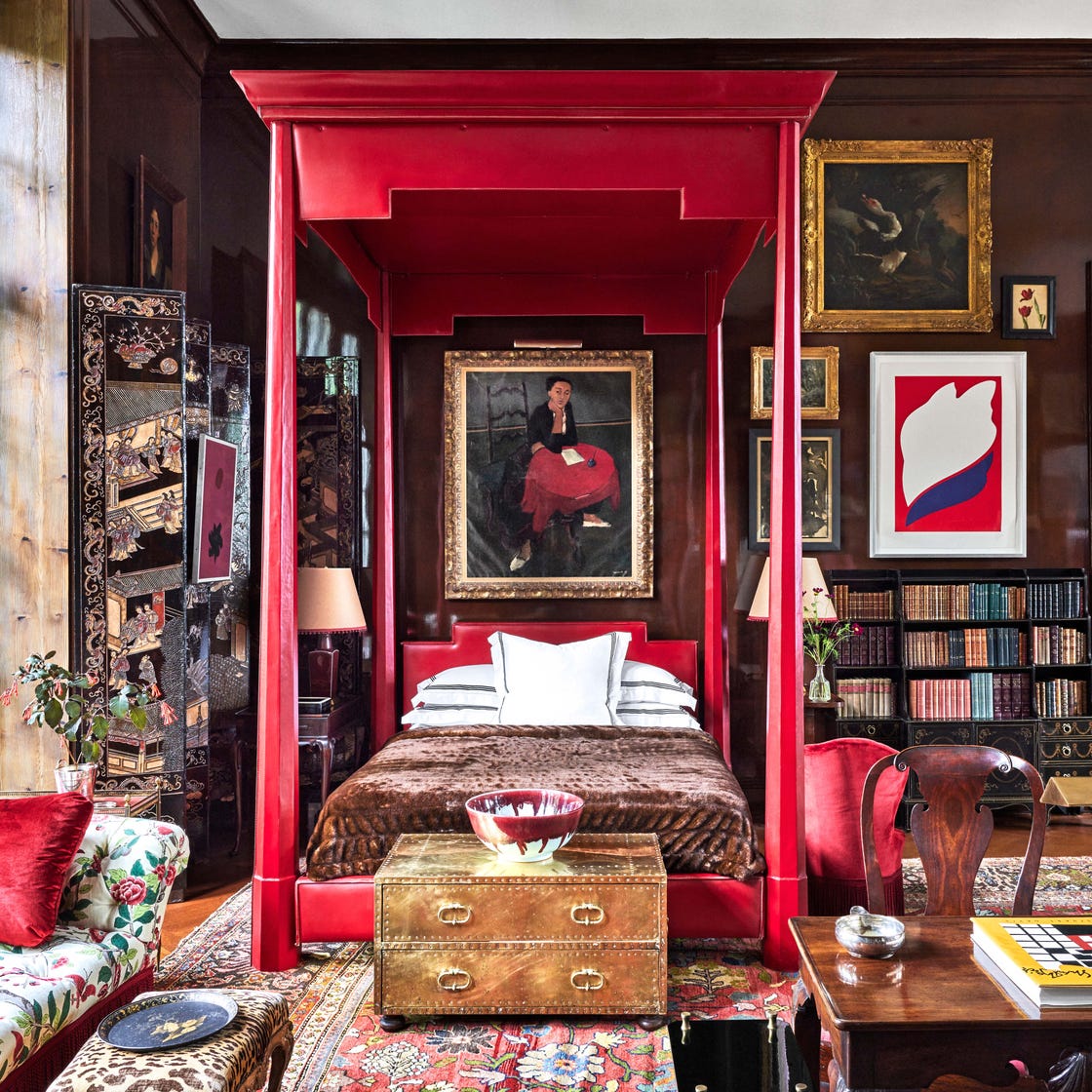 red canopy bed in living room designed by redd kaihoi