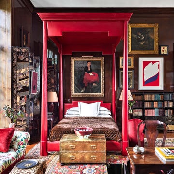 red canopy bed in living room designed by redd kaihoi
