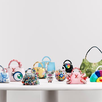 11 bags designed by takashi murakami for louis vuitton on a white table. 11 bags designed by takashi murakami for louis vuitton on a white table.