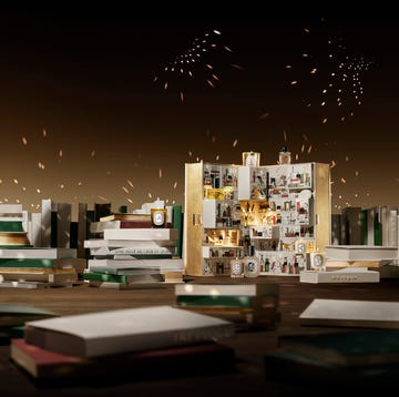 shot of diptyque's advent calendar surrounded by books. shot of diptyque's advent calendar surrounded by books.