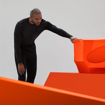 a man standing on a large orange object