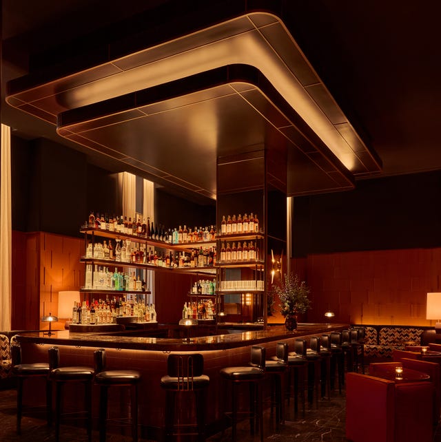 stylish bar interior with a long counter and a wellstocked shelf of liquor bottles stylish bar interior with a long counter and a wellstocked shelf of liquor bottles