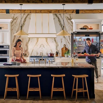 a white man and woman preparing to entertain in a luxurious kitchen