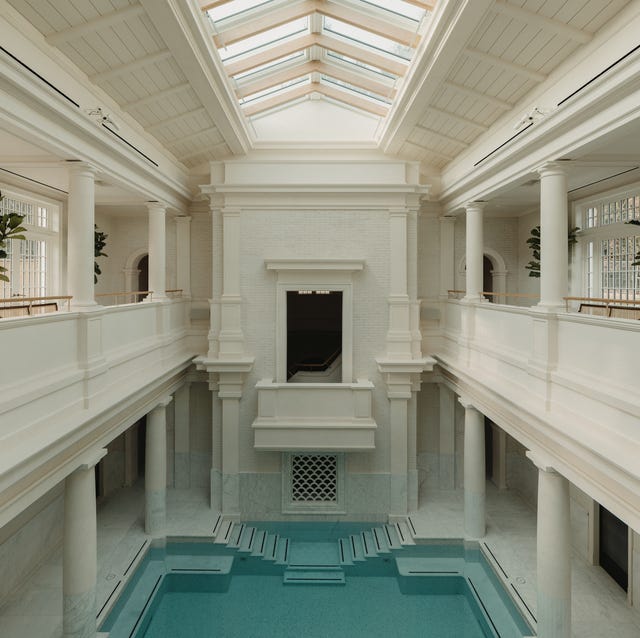 A-List 2024 - ELLE DECOR an roman atrium with balconies overlooking a large pool