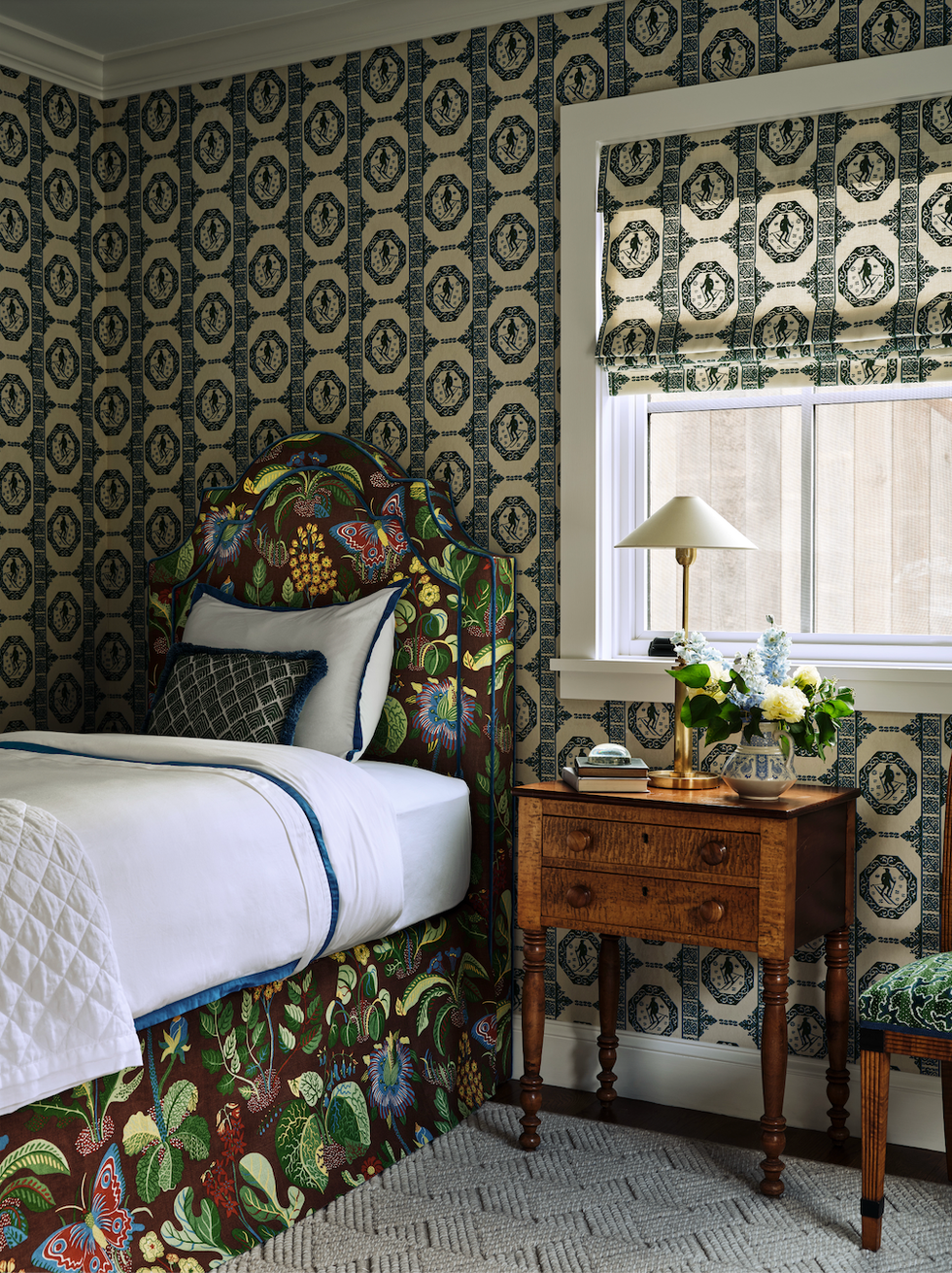 Cozy bedroom featuring a colorful bed and elegant furnishings.