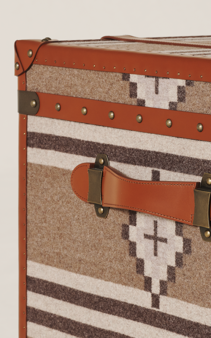 Decorative storage box with patterned fabric and leather accents.