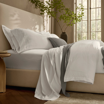 cozy bedding arrangement with pillows and blankets on a bed next to a side table cozy bedding arrangement with pillows and blankets on a bed next to a side table