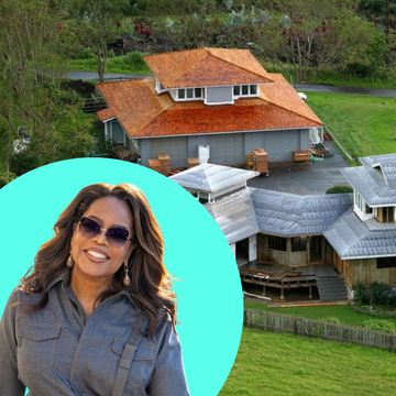 a large modern house surrounded by green lawns and trees